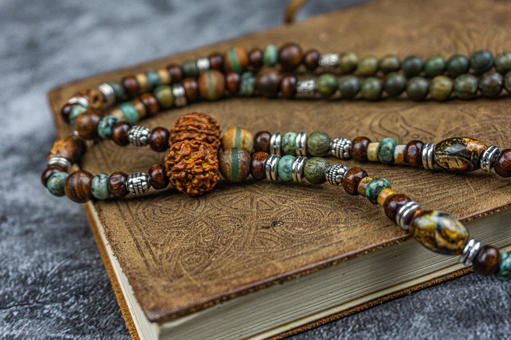 wood, rudraksha and gemstone beads necklace with a silver colored bull skull pendant- wander jewellery