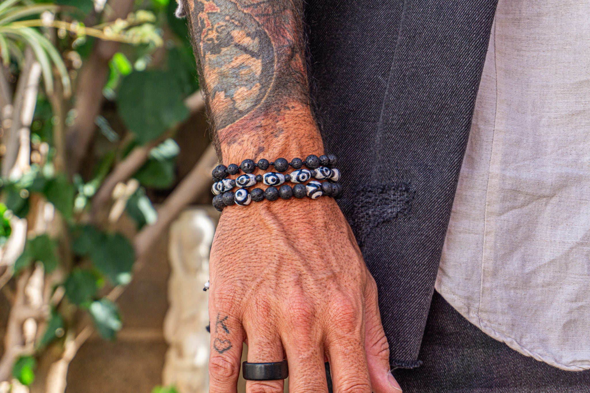 black beaded lava stone triple bracelet set with third eye tibetan beads - wander jewellery