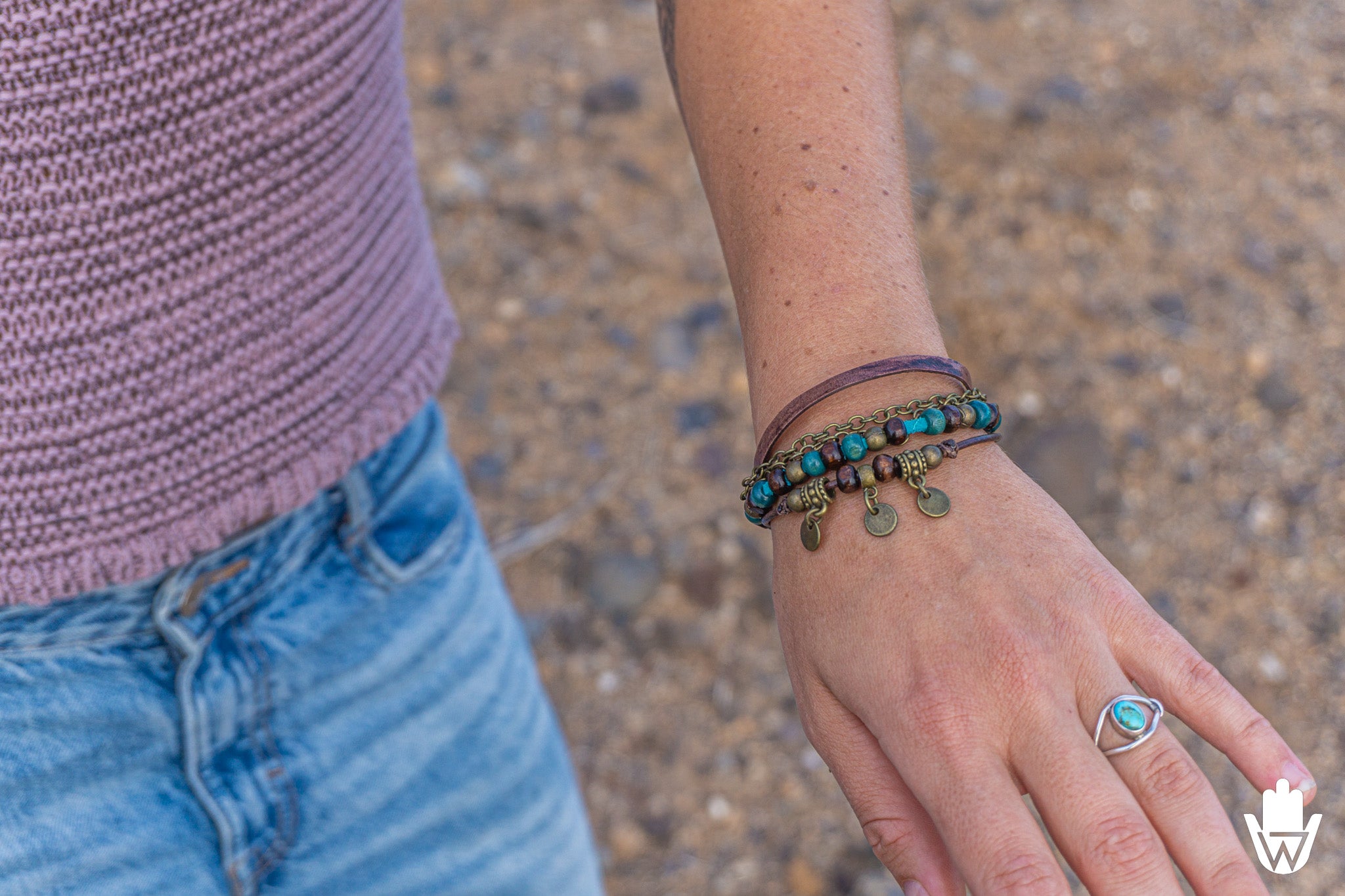 women wearing a bracelet with charms on a blurred background