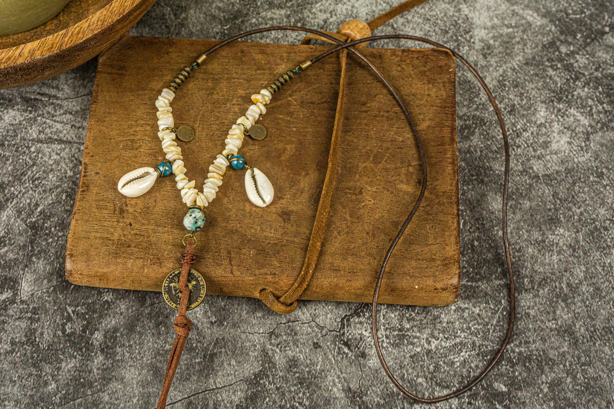 long leather beaded necklace made of brass beads and white coral , with coin and shell charms-wander jewellery