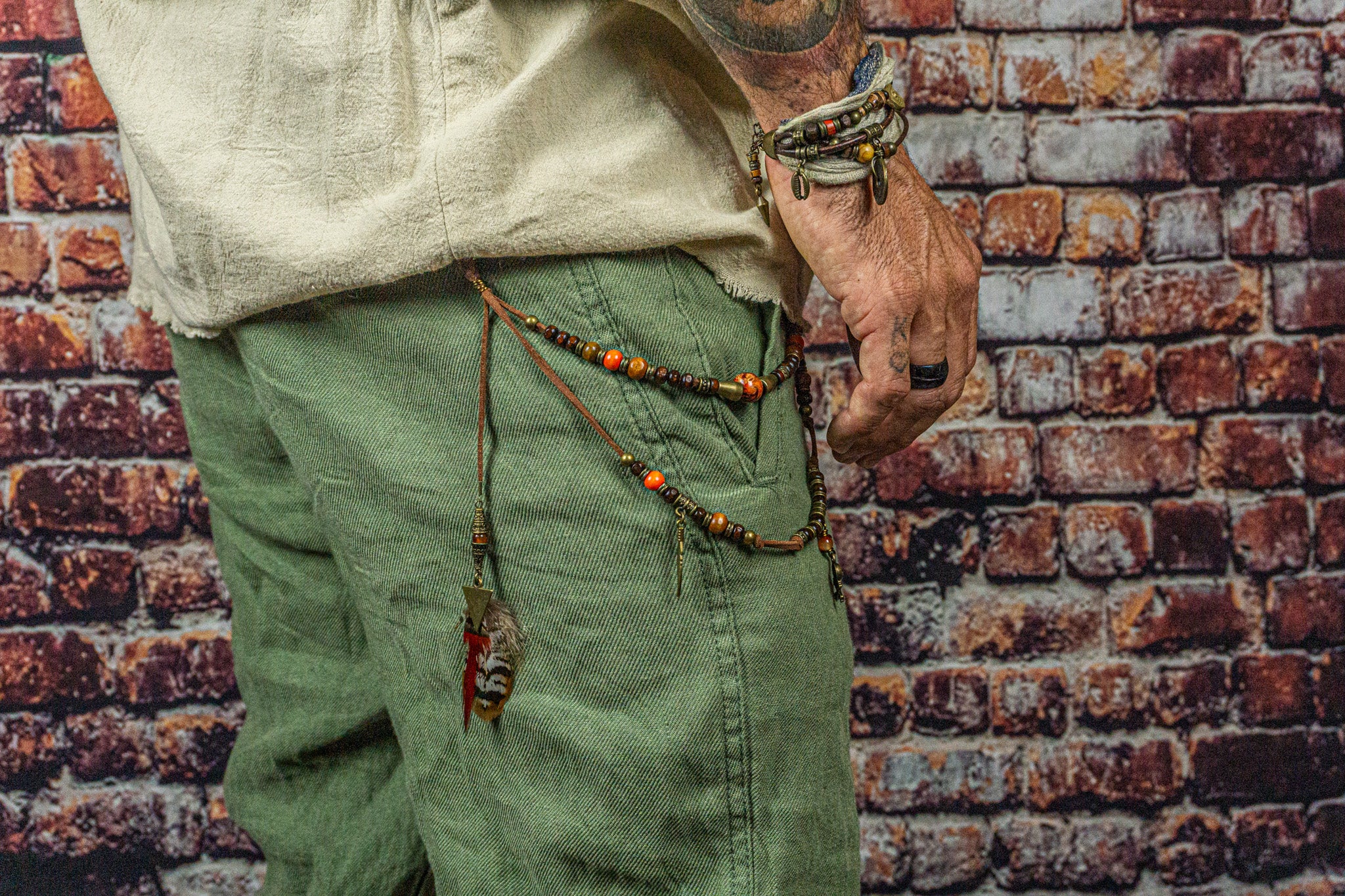 faux leather and wooden bead layered pants keychain with feathers and bronze dangle charms- wander jewellery