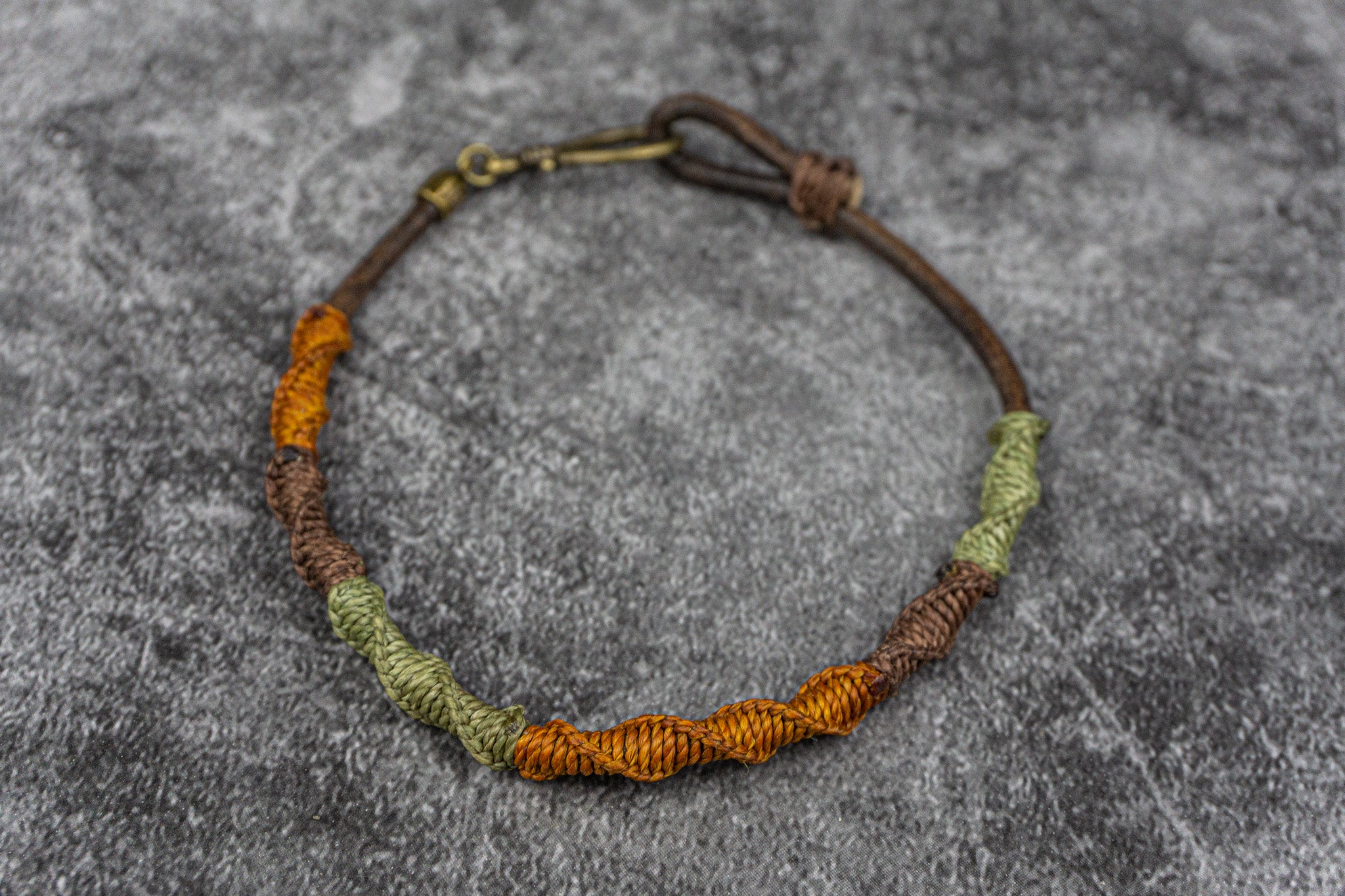 Colorful macrame leather anklet with orange and green pattern, featuring a brass hook closure – Wander Jewellery