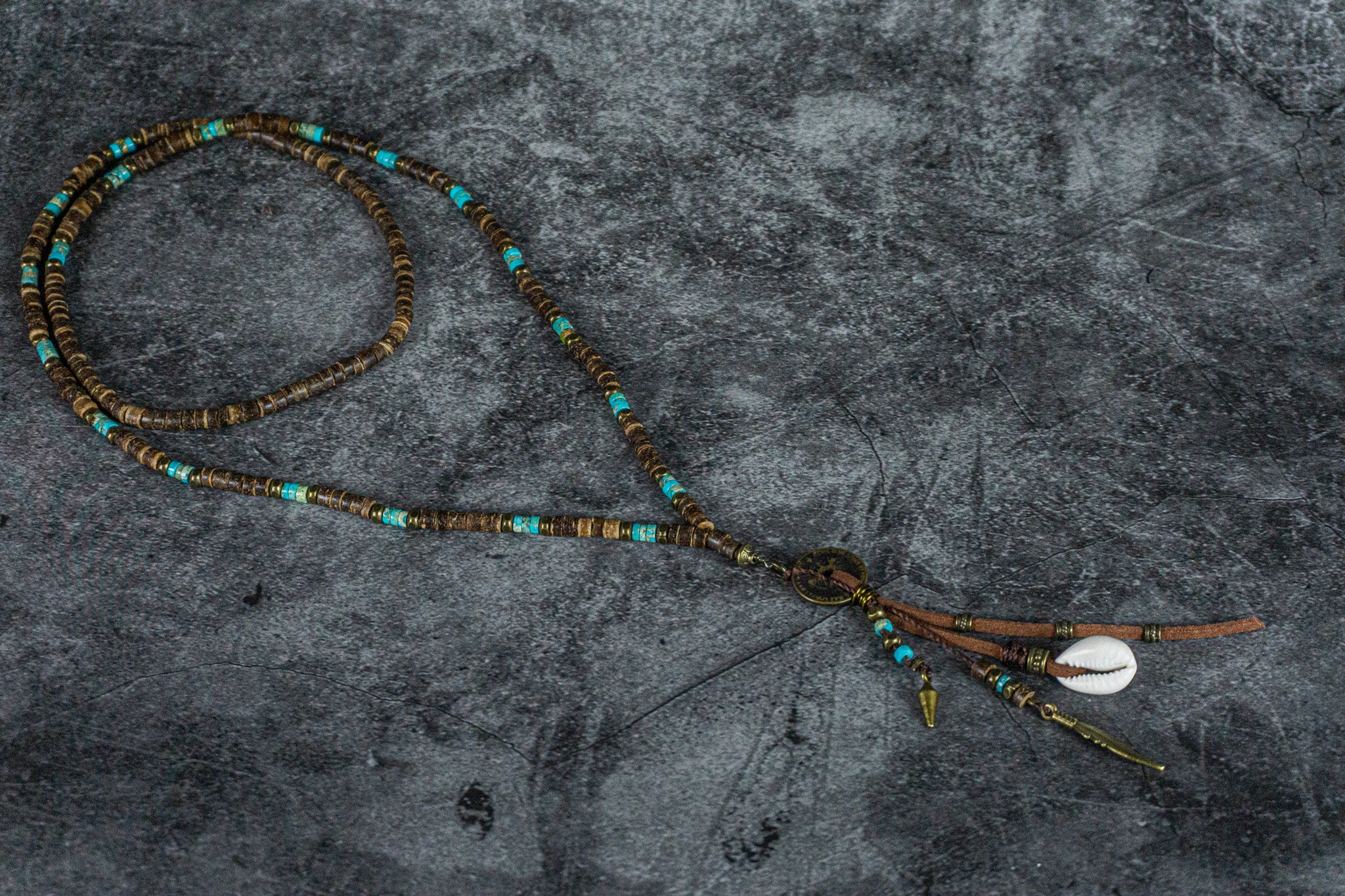 extra long coconut shell and turquoise gemstone bead, with a long tribal multi charm pendant- wander jewellery
