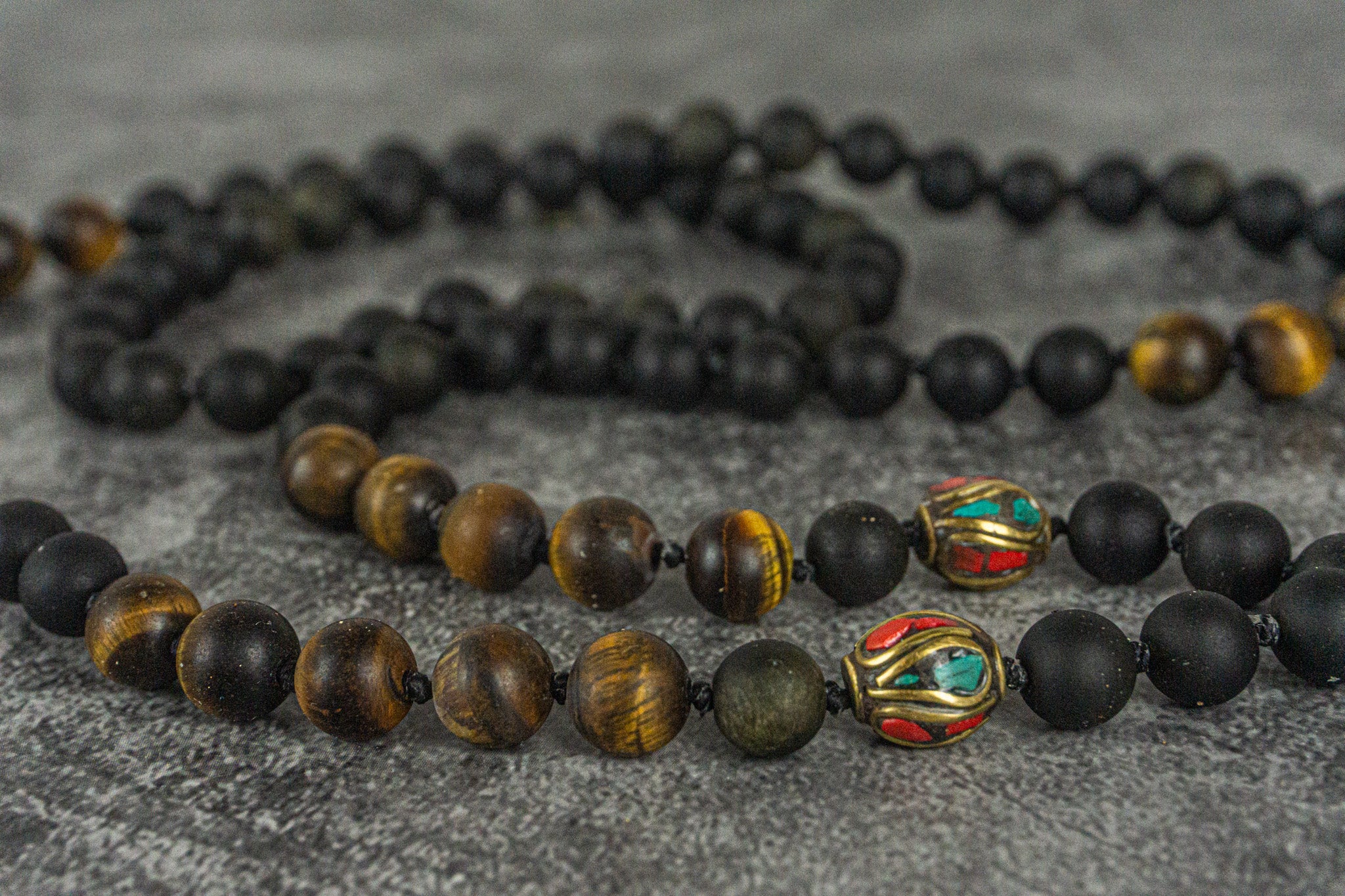 necklace made of golden obsidian and frosted tiger eye gemstones, with tibetan beads decorations- wander jewellery