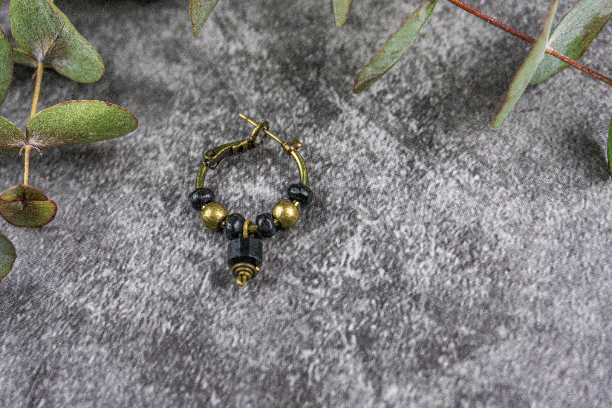 bronze hoop earring with black wooden bead and golden obsidian - wander jewellery