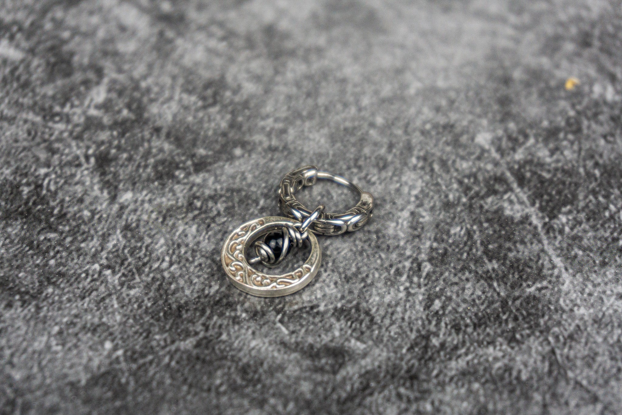 stainless steel hoop earring with an abstract moon charm with a dangle onyx bead- wander jewellery