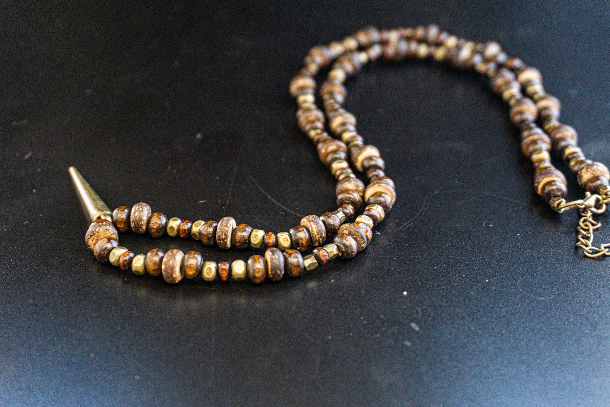 wood and coconut beaded necklace with an antique  bronze pendant- wander jewellery