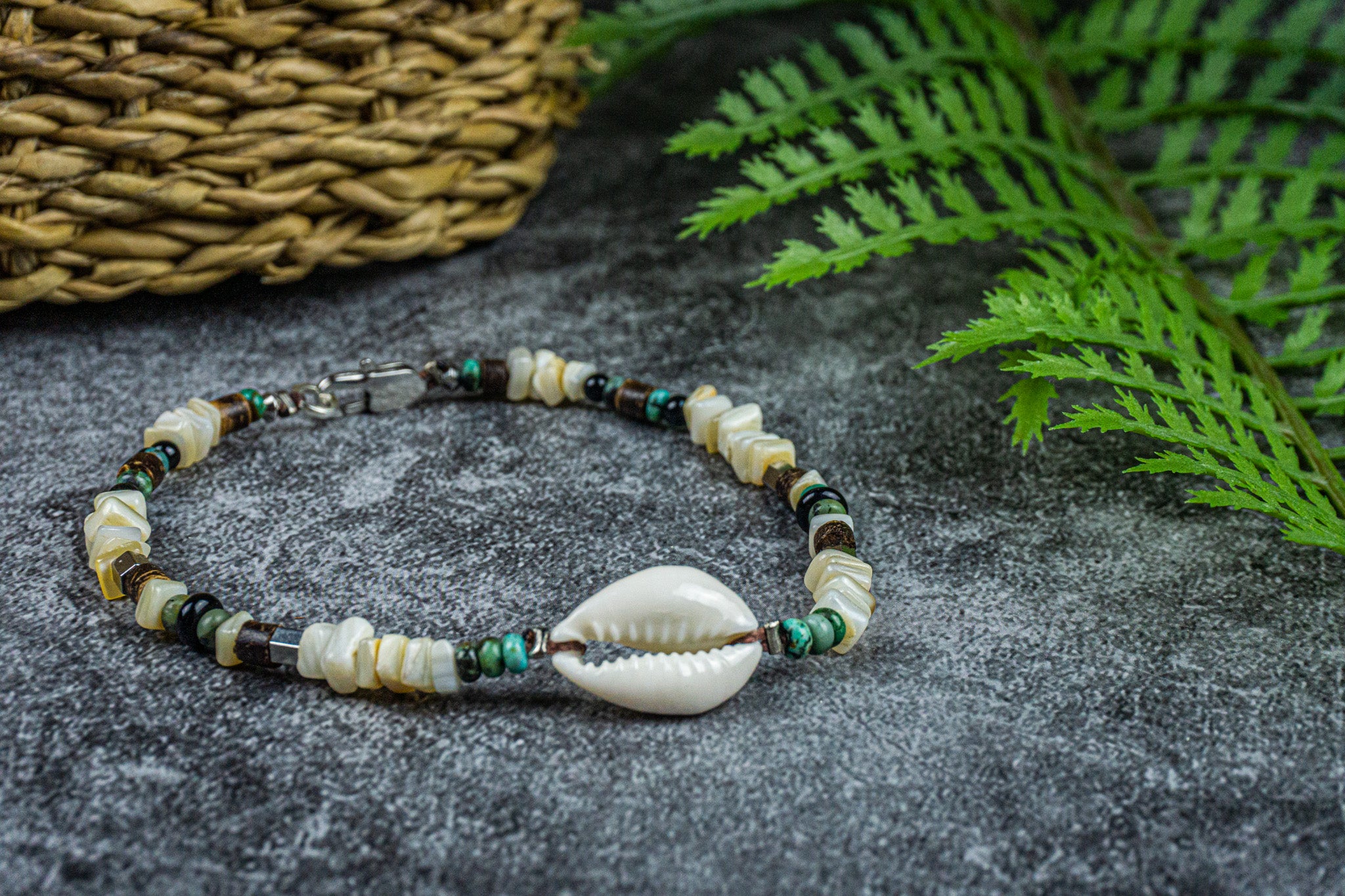 white coral anklet with green jasper gemstone and a cowrie shell- wander jewellery