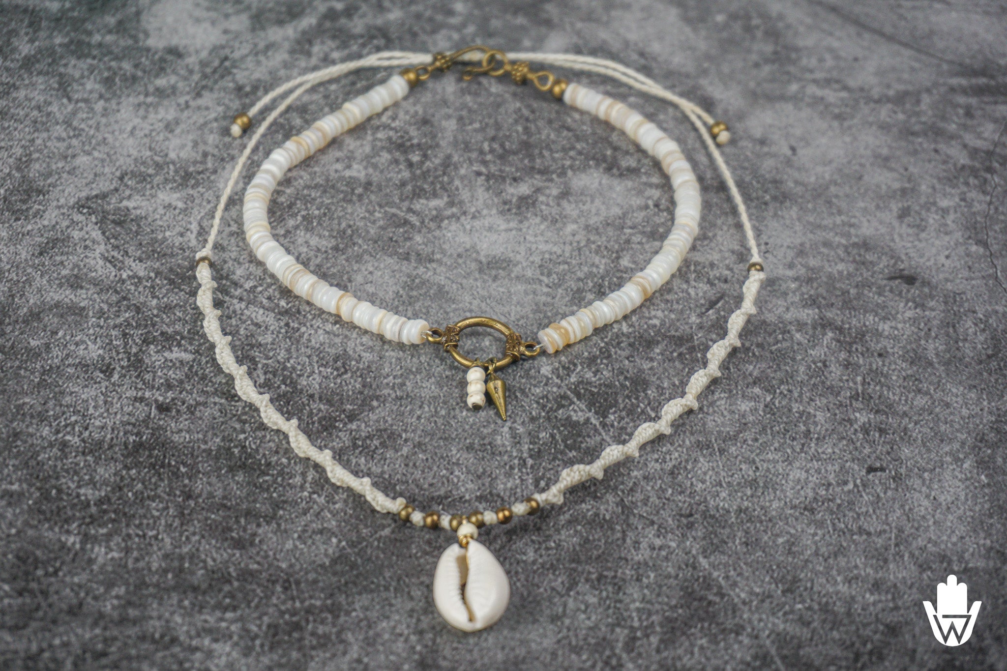 necklace set made of a white choker and a macrame necklace with a shell