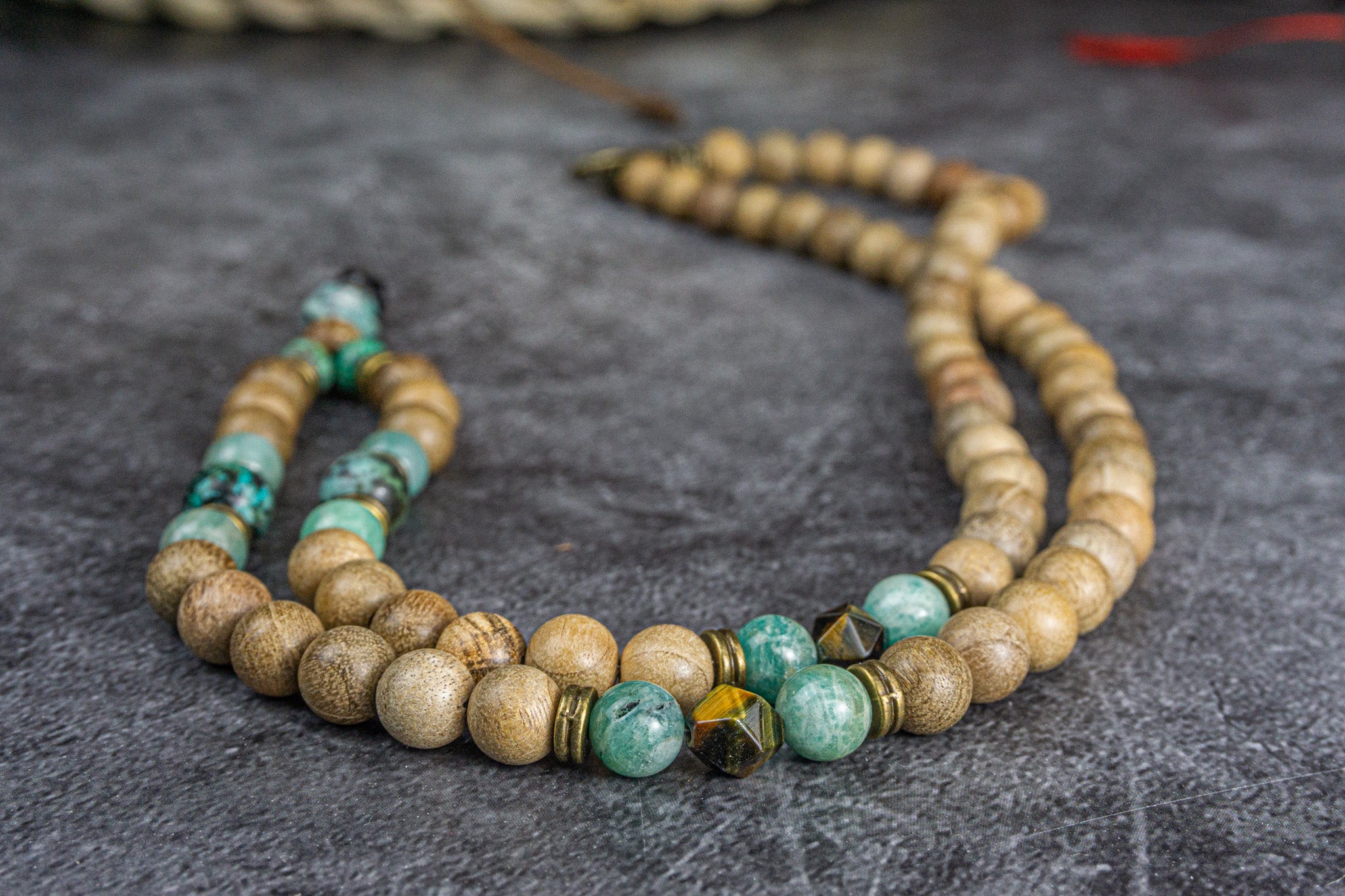 detailed picture of a camphor wood, amazonite, jasper and tiger eye gemstone beaded boho tibetan necklace