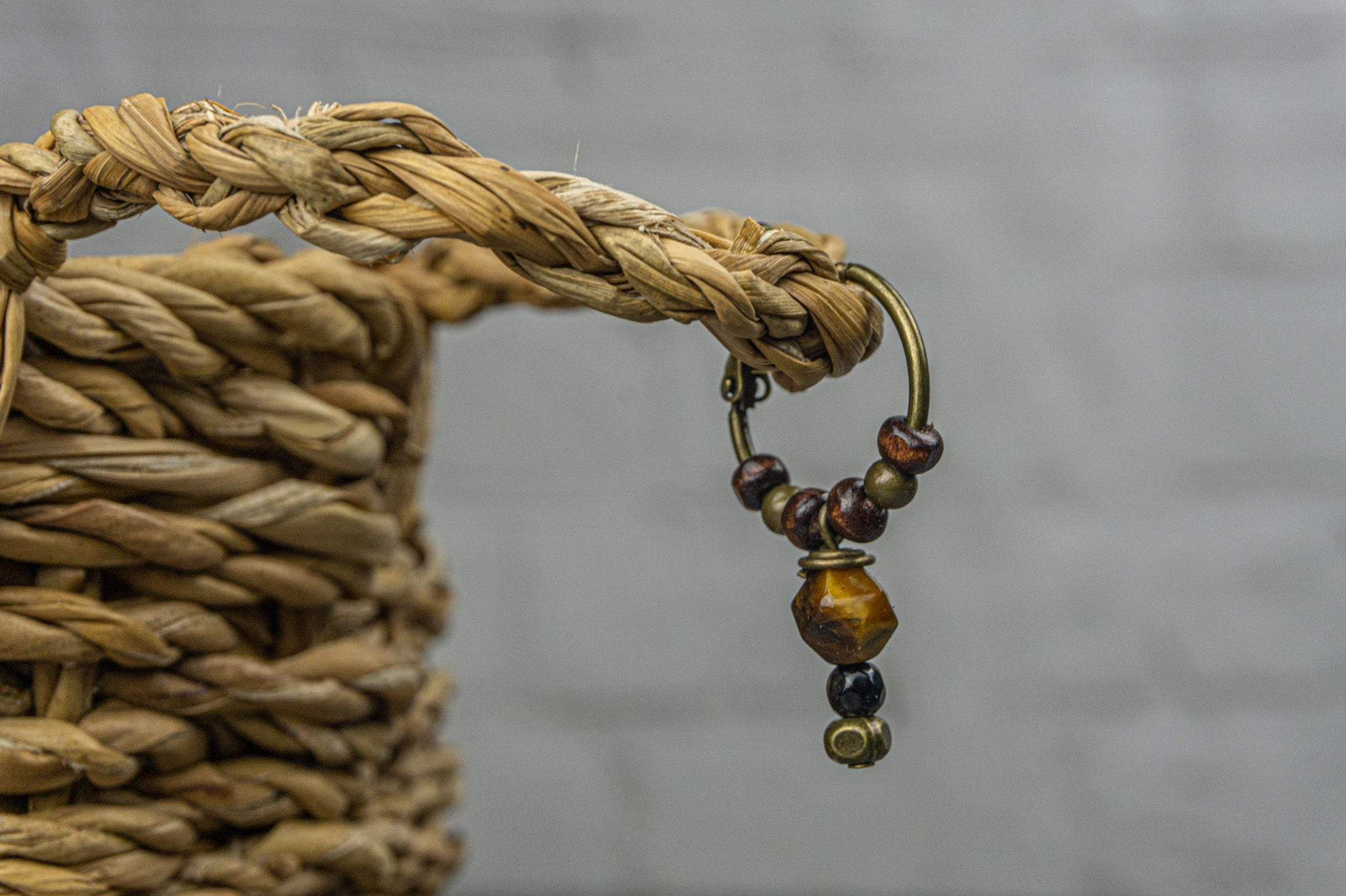 Hoop earring with wood, bronze beads and a dangling tiger eye stone