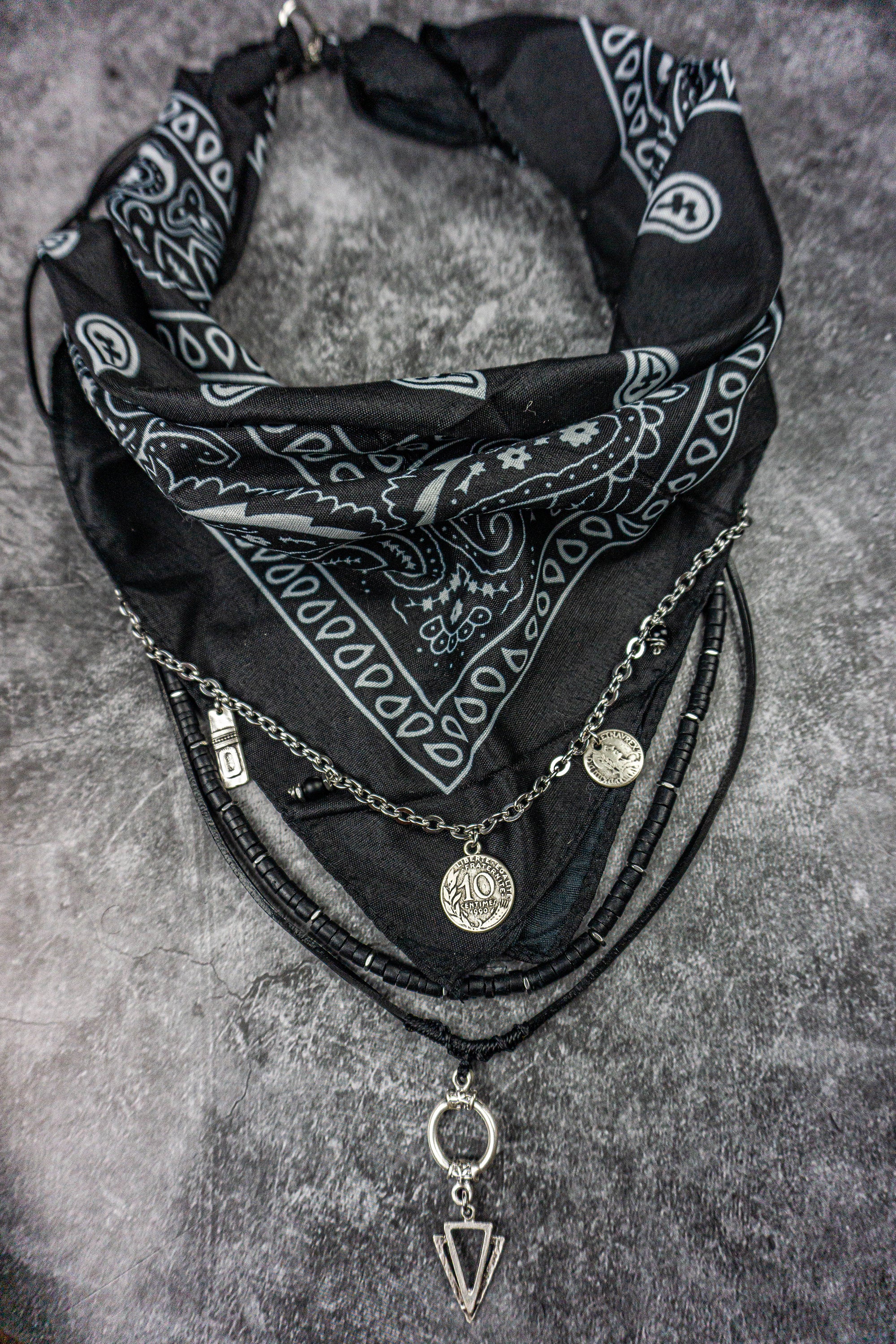 black bandana layered necklace made of stainless steel chain strand, black leather strand with arrowed pendant and black coconut 