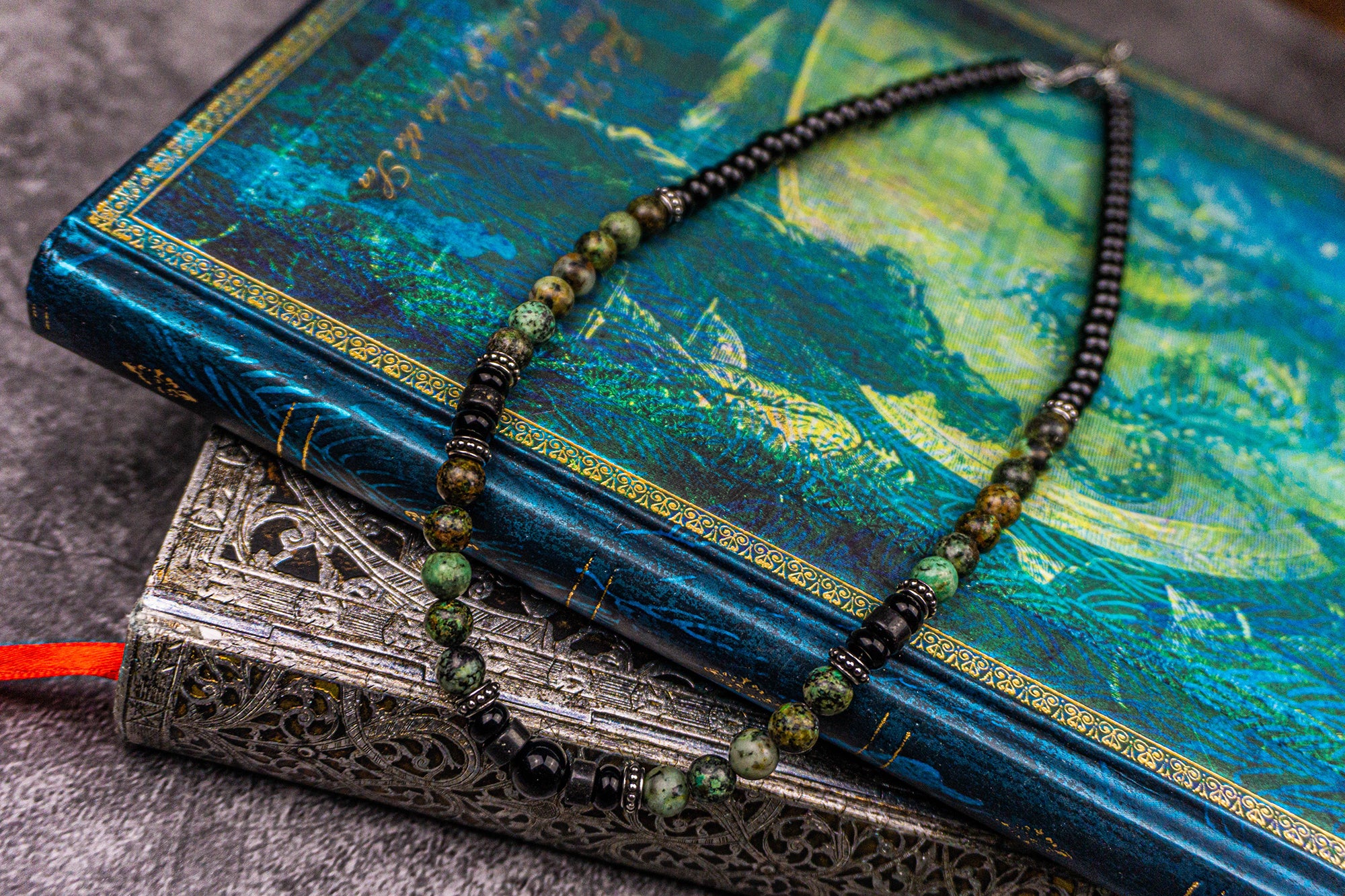 picture of a necklace made of black onyx and green african turquoise gemstones, and stainless steel spacer beads