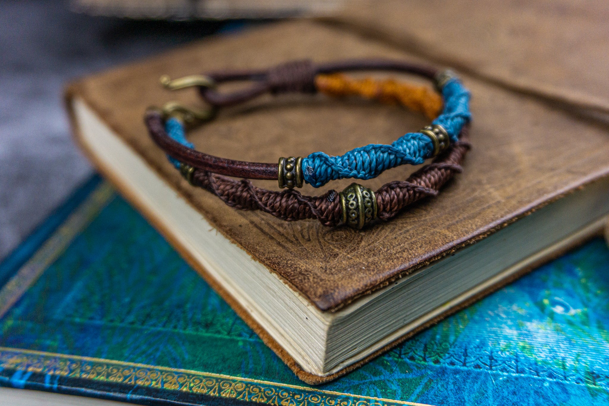 colorful blue orange and brown bracelet set made of leather and decoreted with bronxe details and macrame patterns- wander jewellery