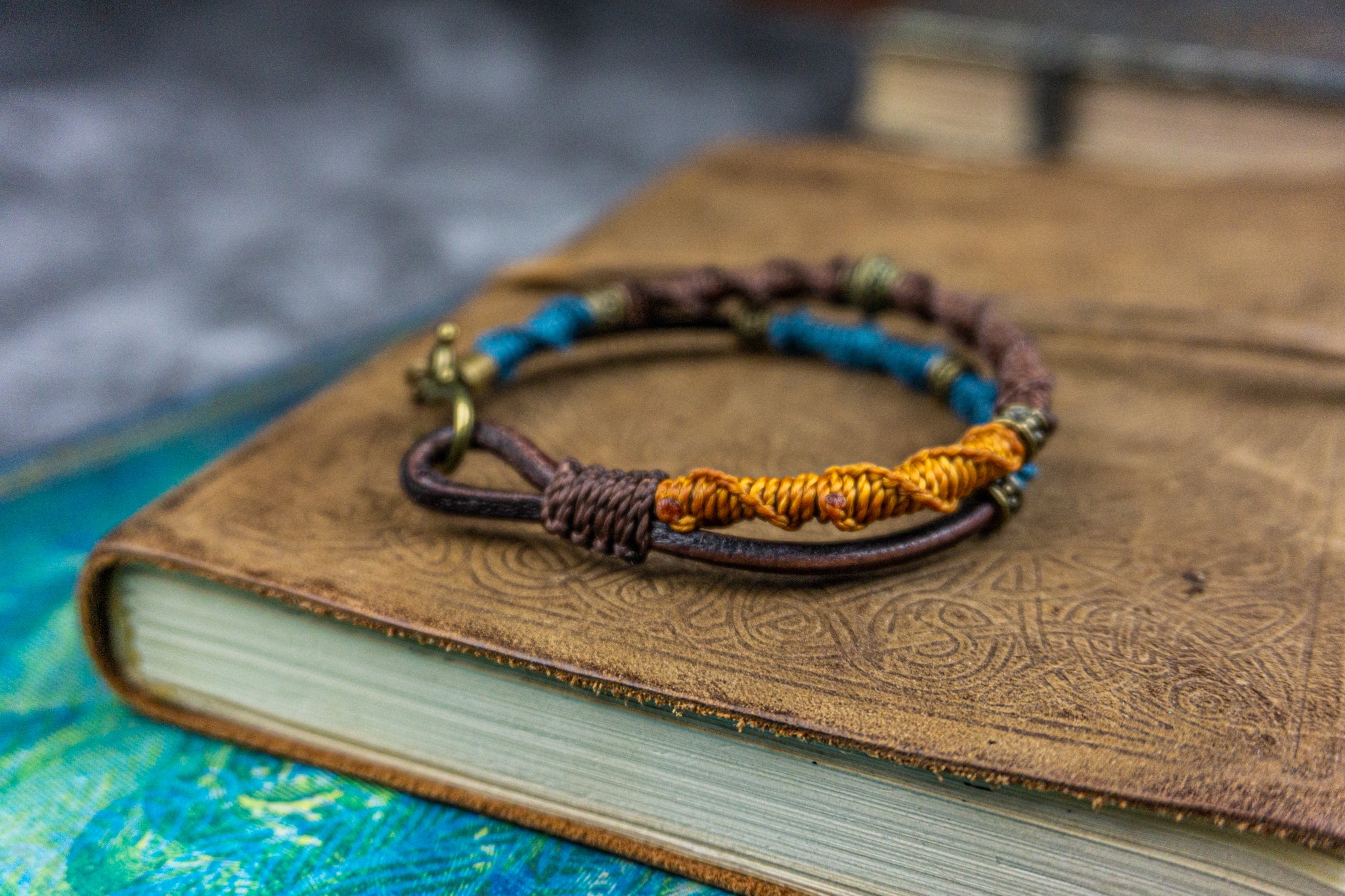 colorful orange bracelet set made of leather and decoreted with bronxe details and macrame patterns- wander jewellery