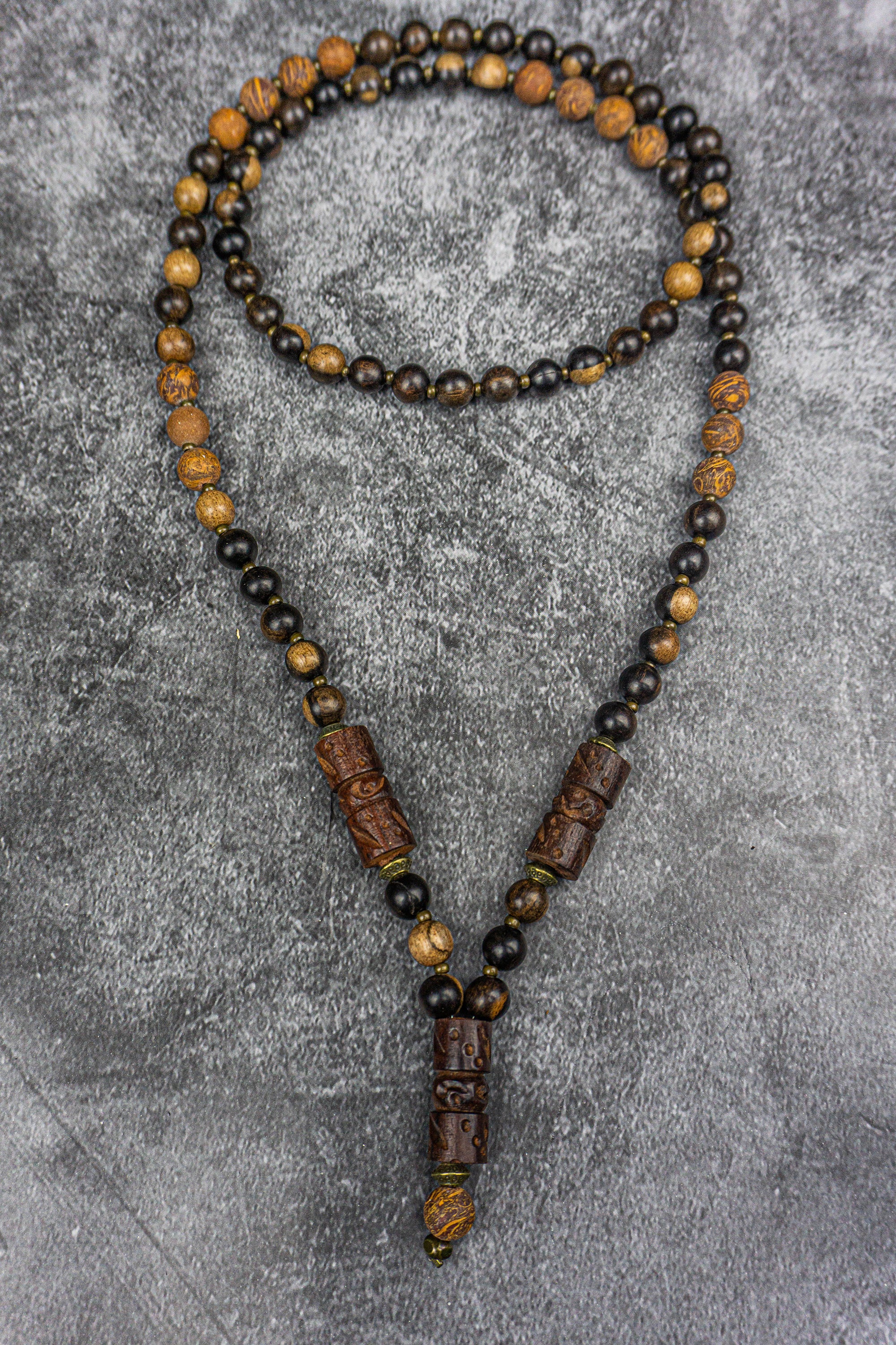 dark ebony wood and elephant skin beaded necklace with bronze details and three carved ebony wood central pieces