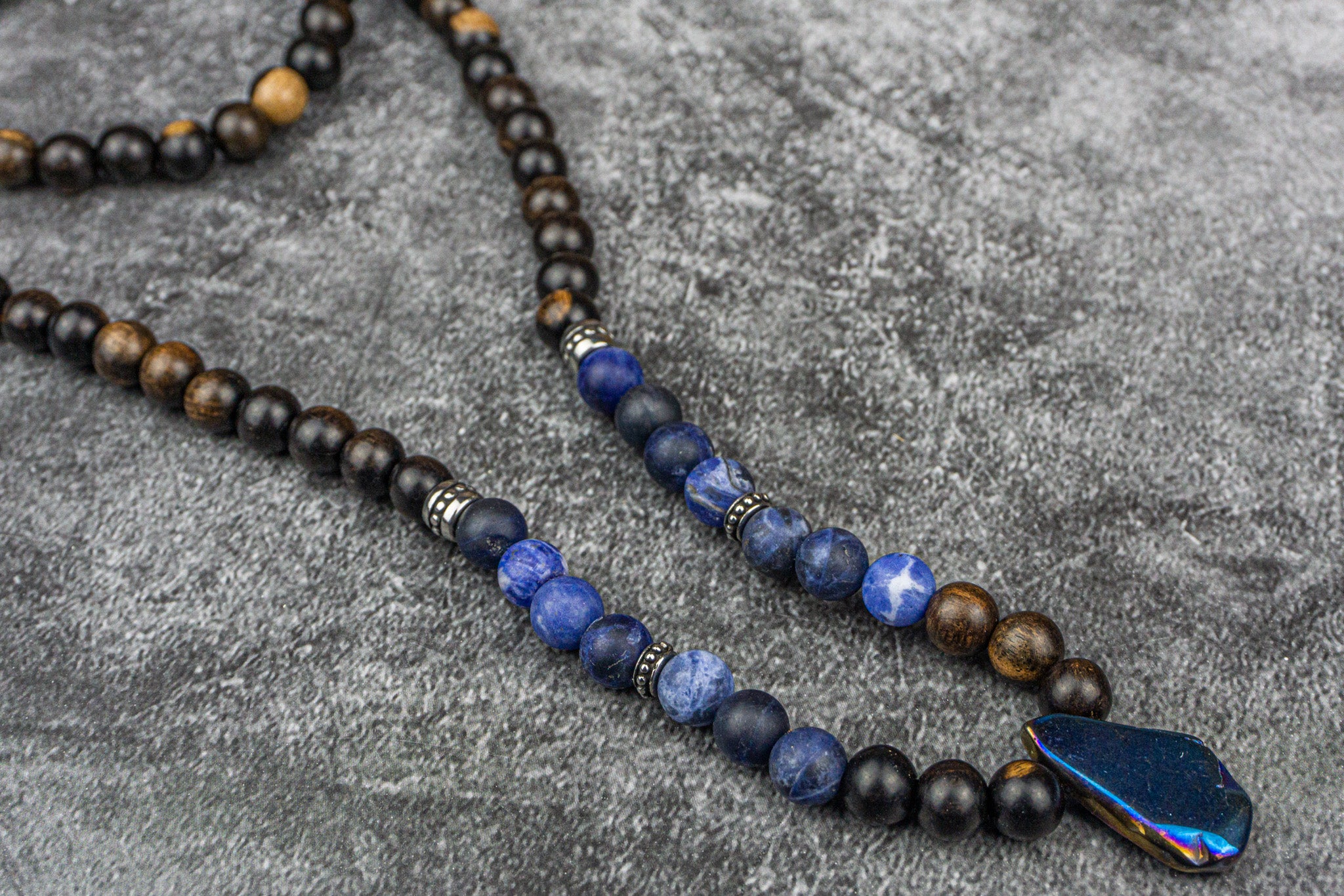 ebony wood, sodalite gemstone and stainless steel beaded necklace with quartz crystal pendant
