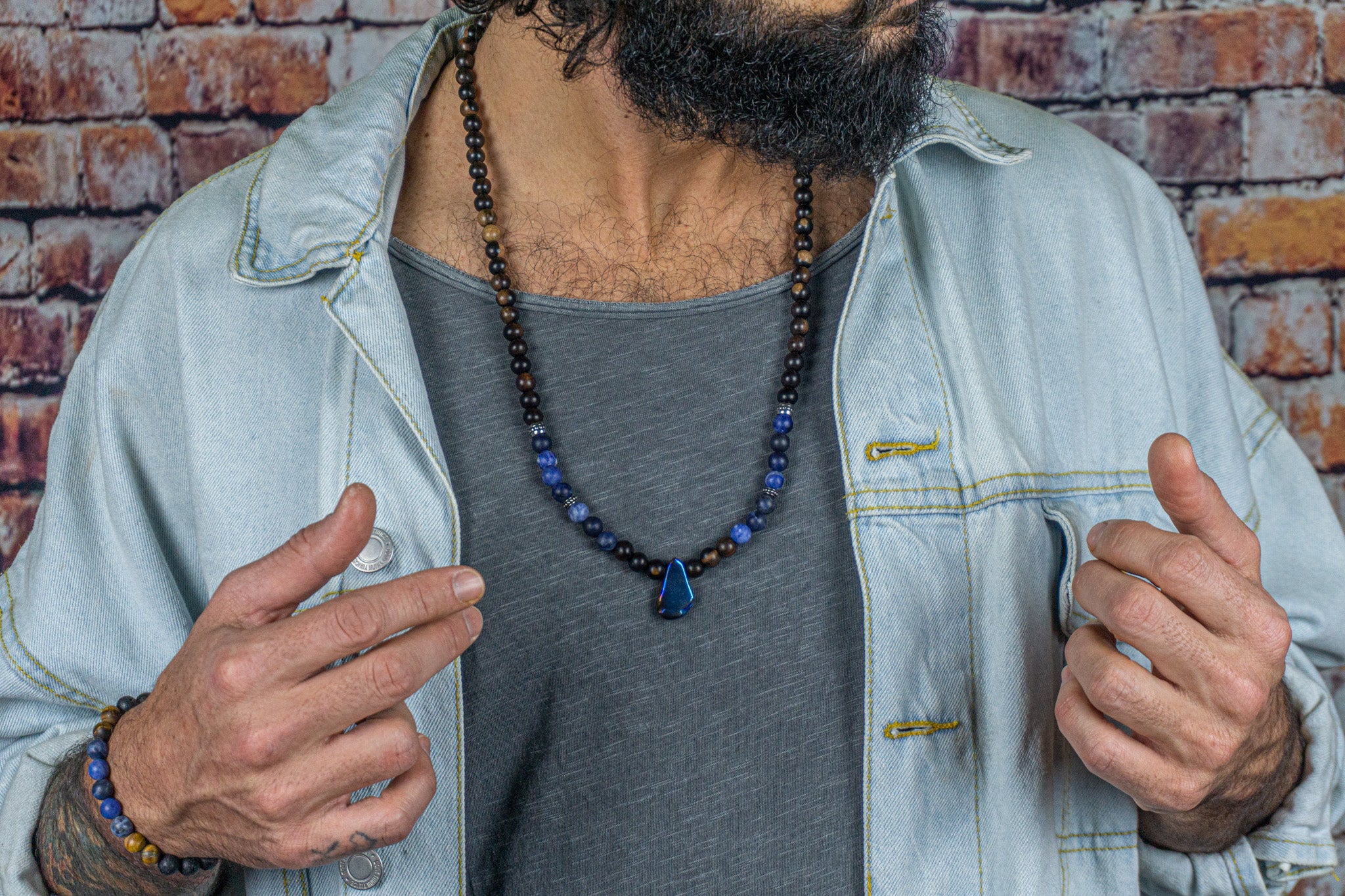 ebony wood, sodalite gemstone and stainless steel beaded necklace and a  quartz crystal as central pendant