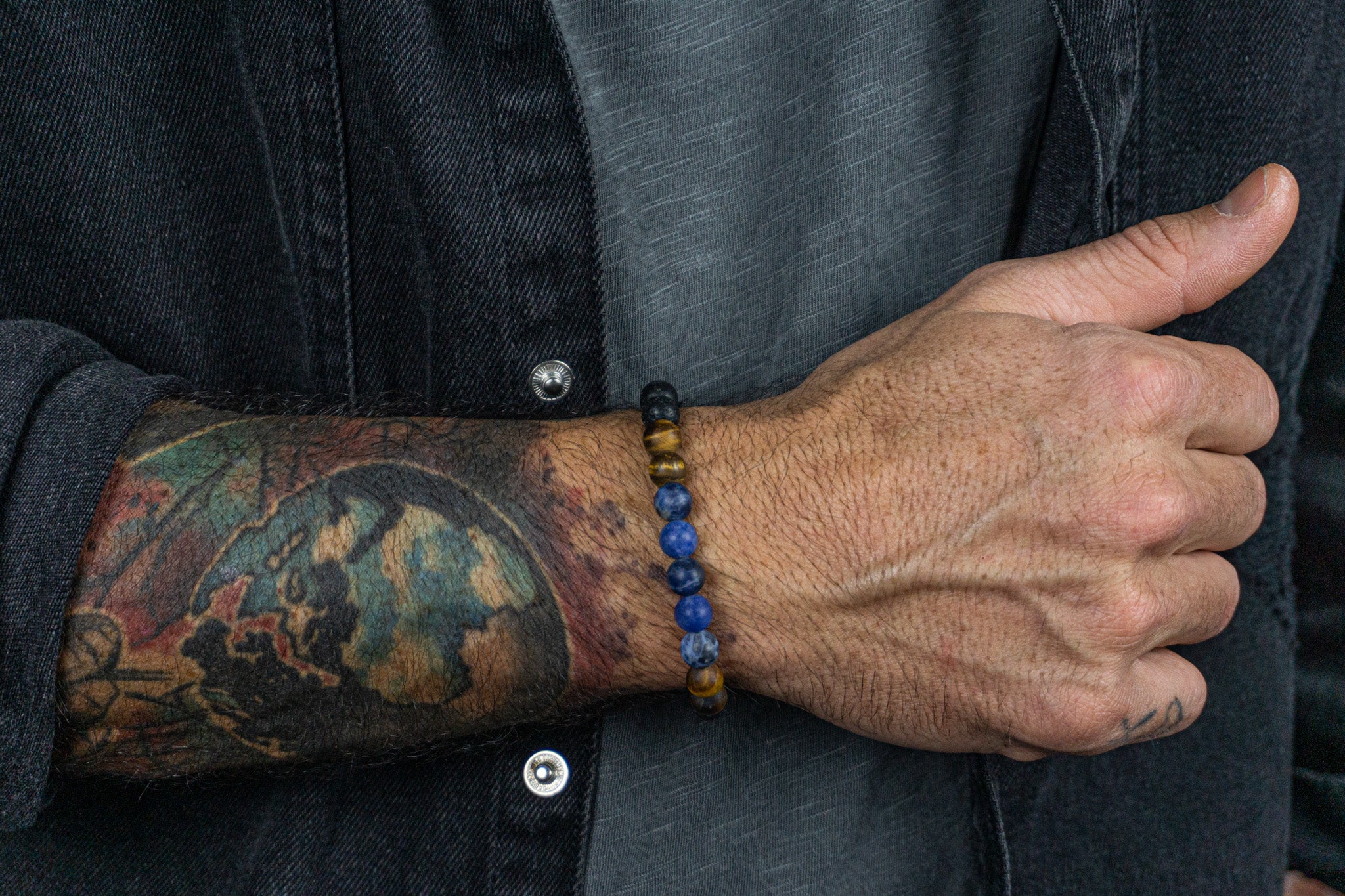 bracelet made of lava stone tiger eye sodalite, weared by a men