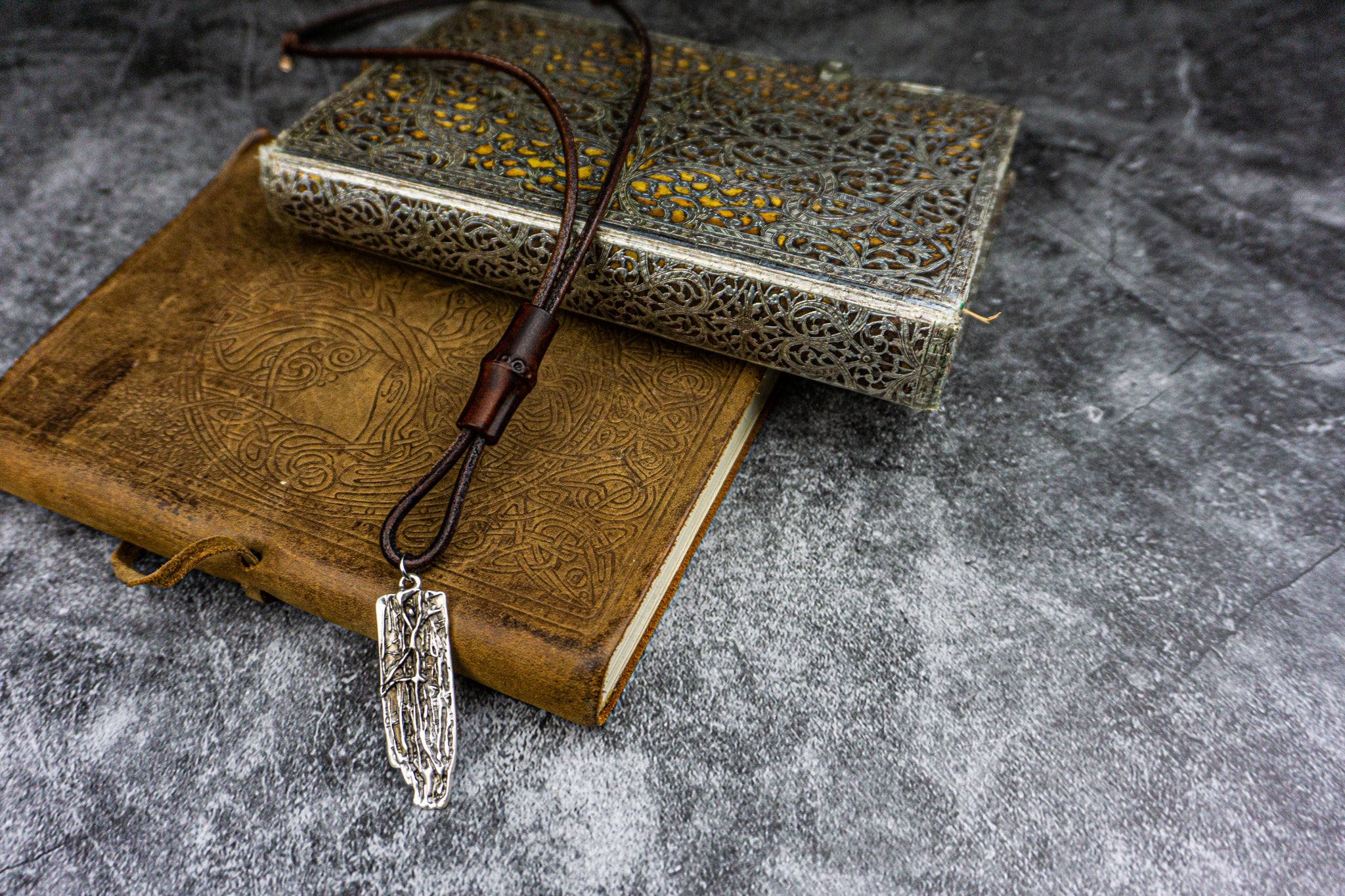 hunky leather necklace with a silver colored abstract pendant