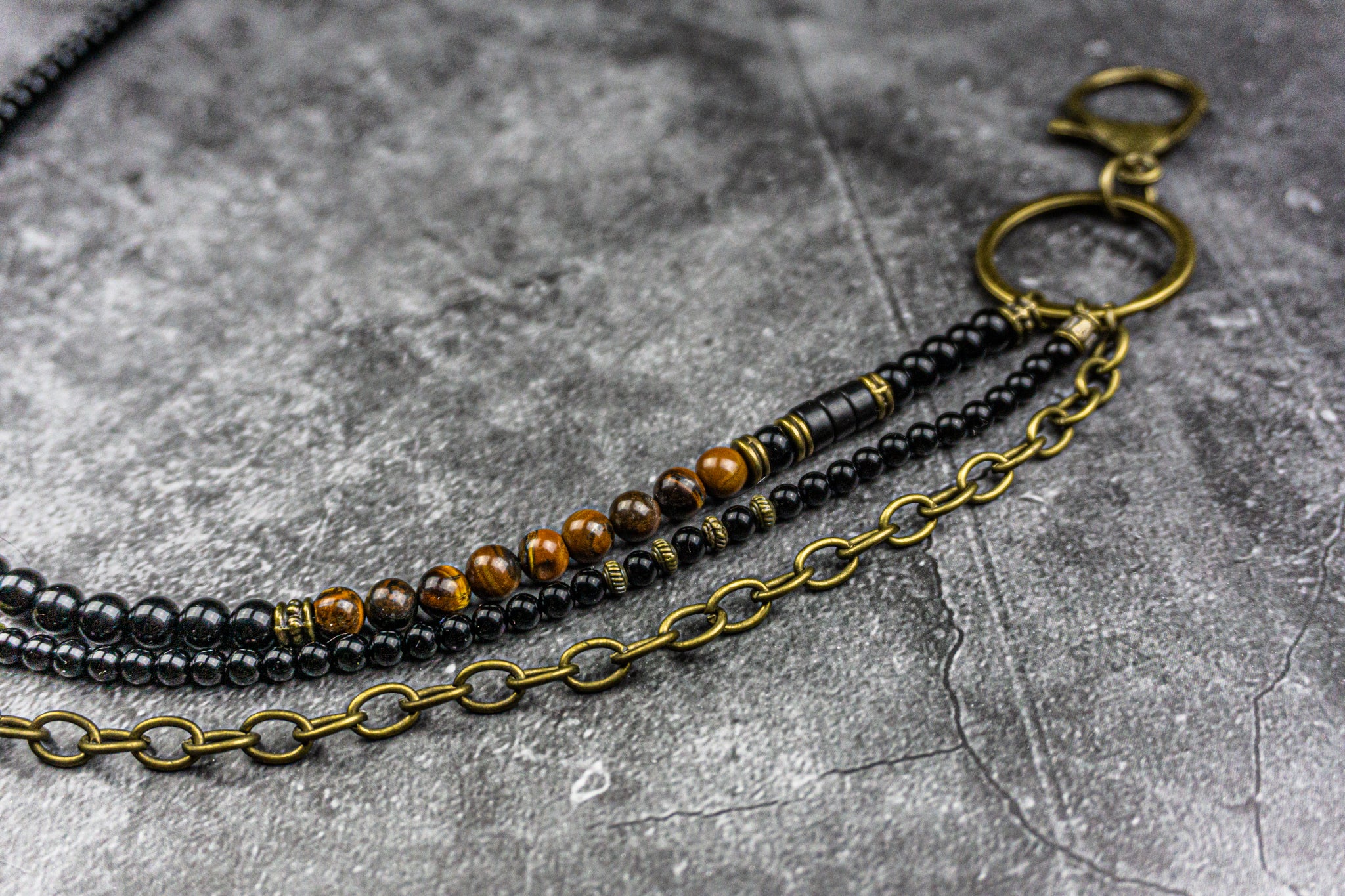pants key chain multistrand made of onyx and tiger eye beads and a bronze chain