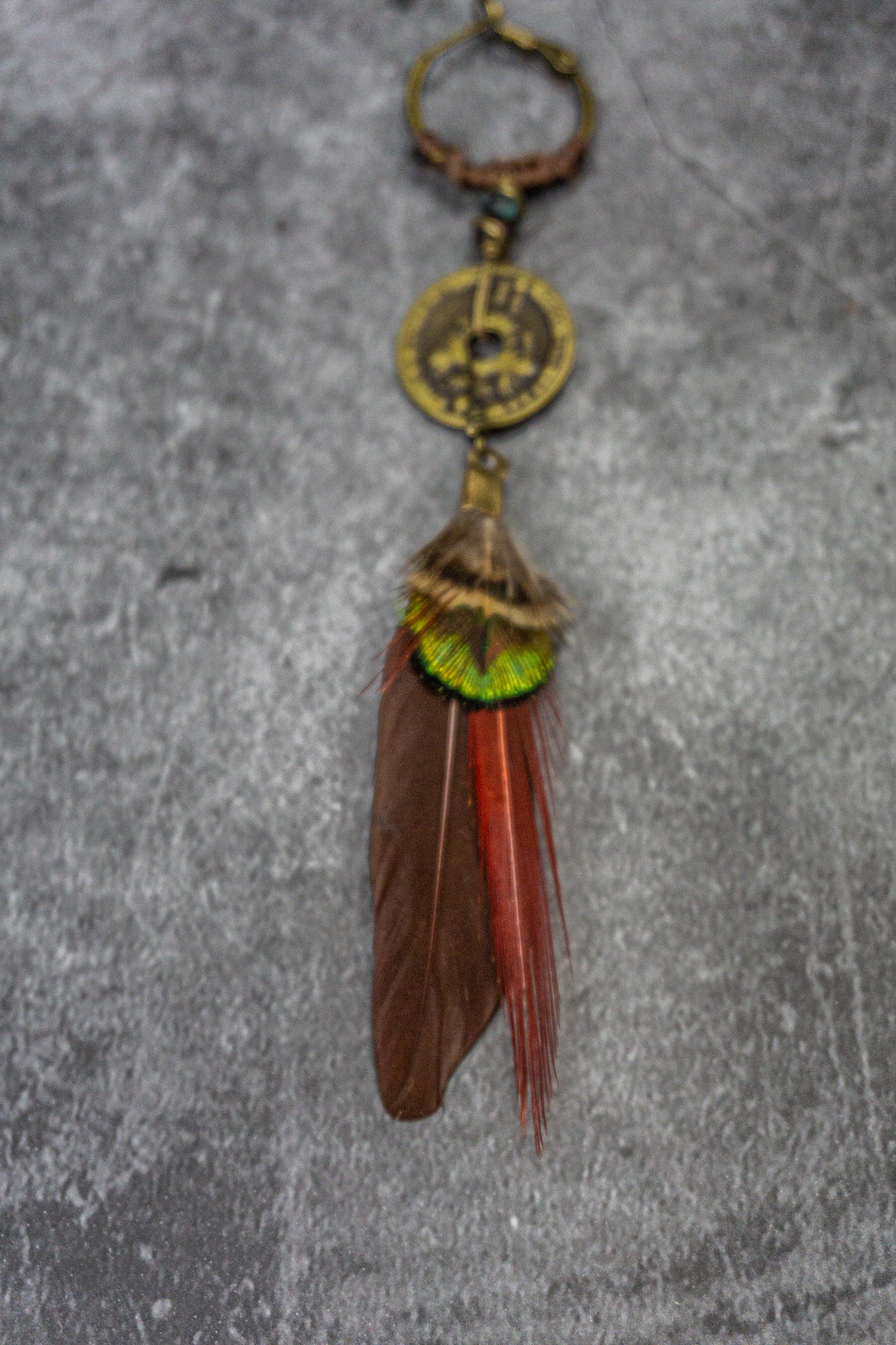 bronze hoop earring with a gemstone and a dangle coin, with an assemblage of naturals feather- Wander Jewellery