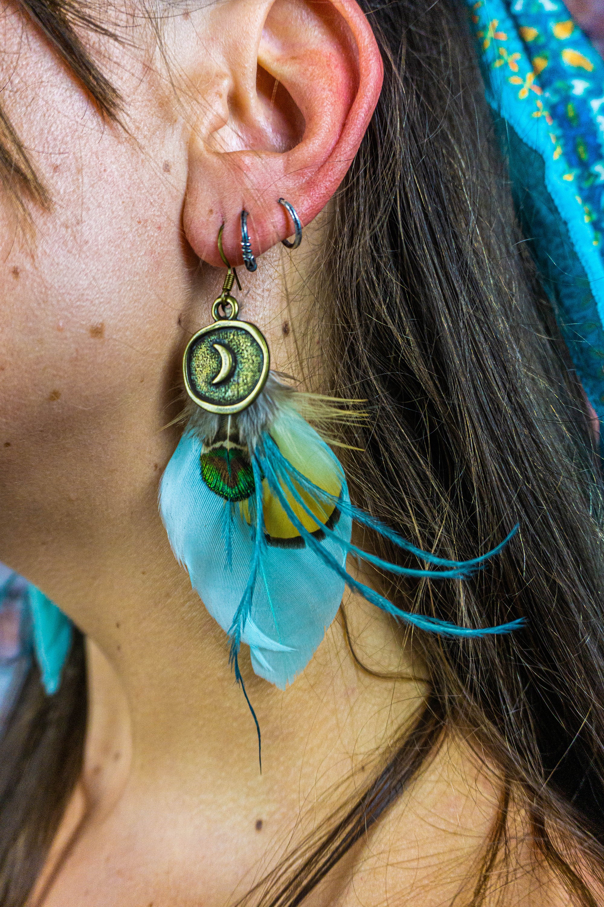 assemblage of real feathers long boho earring with a dangle moon coin