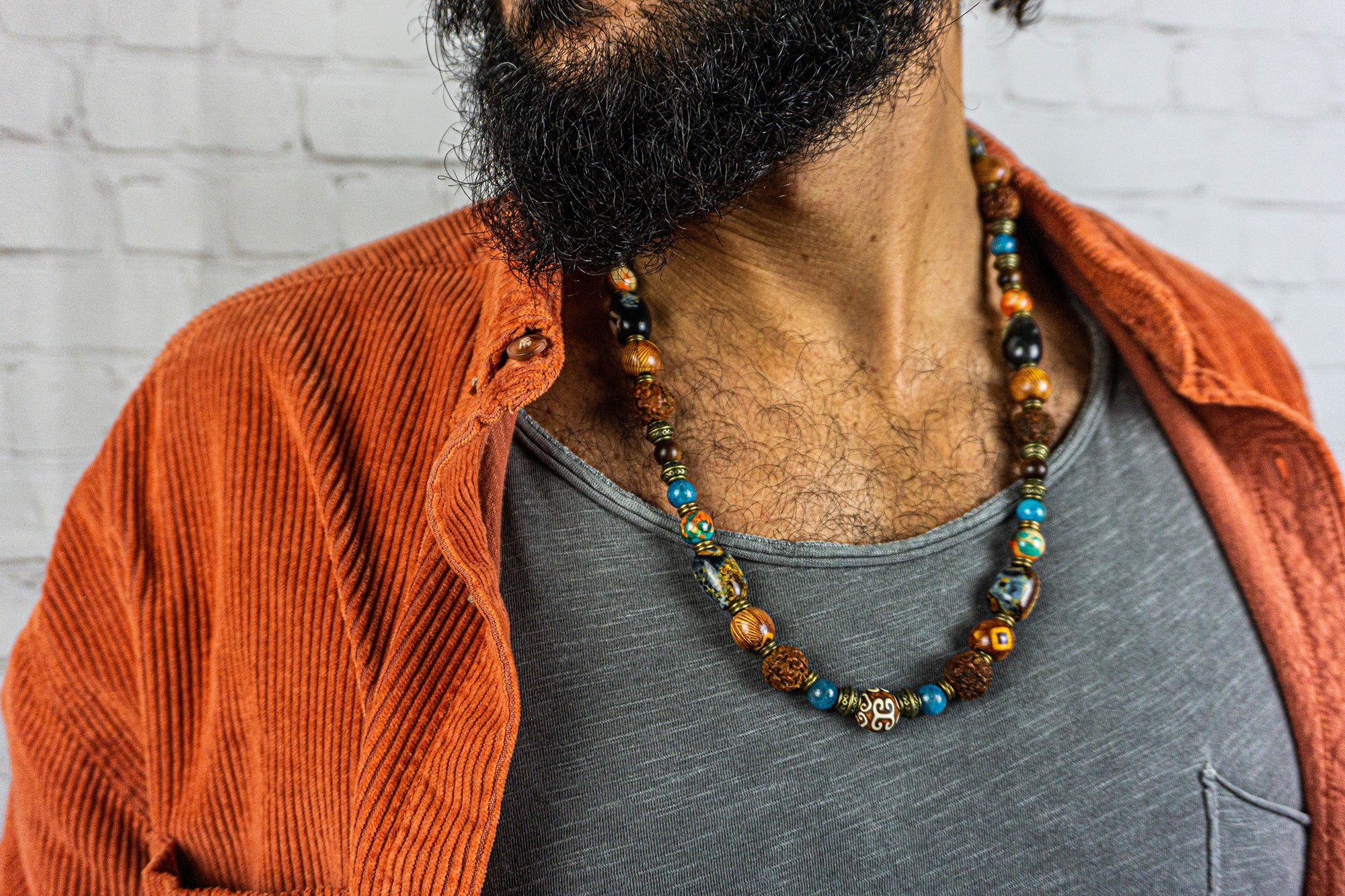 mens wearing a chunky multi colors and multi beads  necklace made of wood, rudraksha, apatite blue gemstones, big agate fire beads and brass spacer beads- wander jewellry